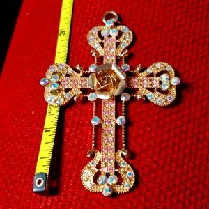 Cross pendant. Rose in middle.
